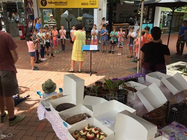 Children's recorder group performing in city square
